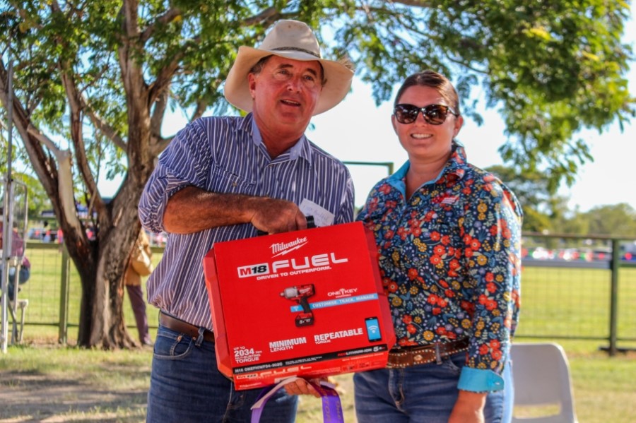 Sarah Zammit of Hughenden Freight presents the Most Successful Commercial Exhibitor winner Stuart Christensen with his new Rattle Gun